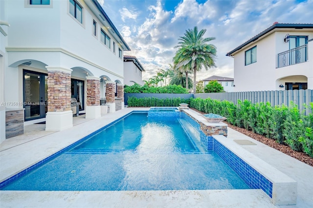 view of swimming pool featuring a patio area and pool water feature