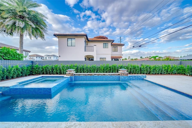 view of pool featuring an in ground hot tub