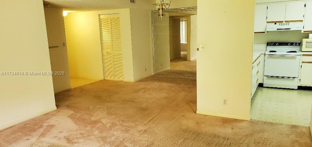 hallway featuring light colored carpet