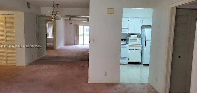 hallway with carpet flooring and visible vents