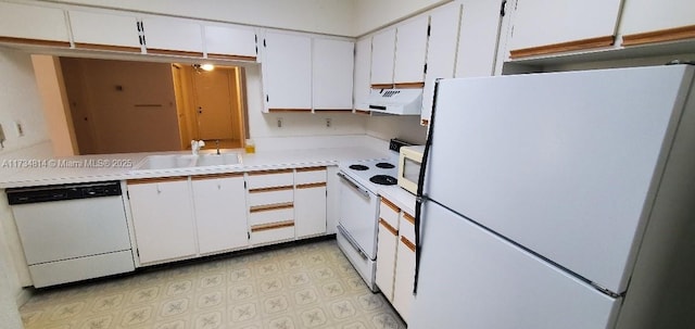 kitchen with white cabinets, white appliances, under cabinet range hood, and light countertops