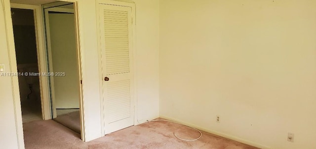 unfurnished bedroom featuring light colored carpet