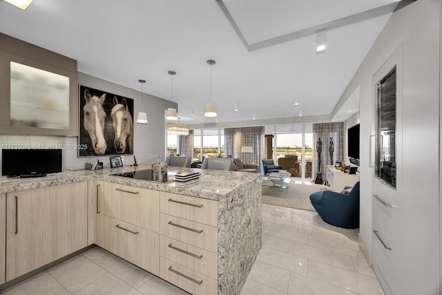 kitchen with pendant lighting, light tile patterned floors, black electric cooktop, light brown cabinetry, and kitchen peninsula