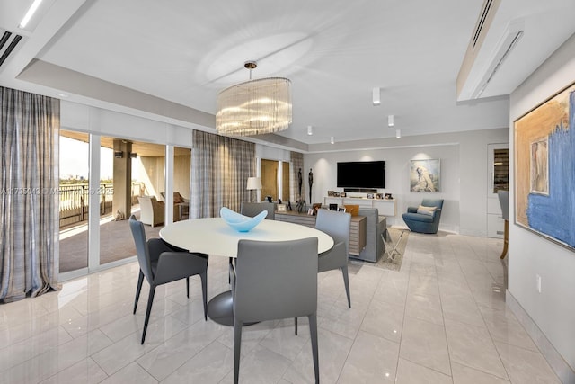 dining space featuring a notable chandelier