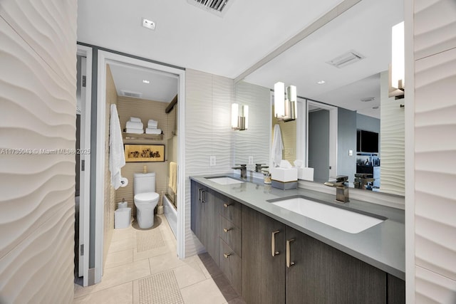 bathroom featuring vanity, toilet, and tile patterned flooring