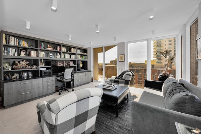 tiled living room with built in desk, built in features, and expansive windows