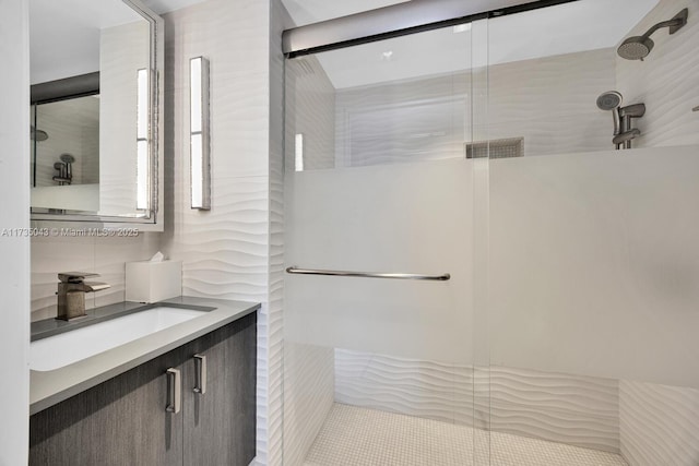 bathroom featuring vanity and an enclosed shower