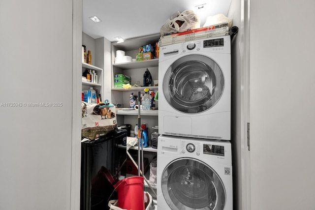 clothes washing area with stacked washer and dryer