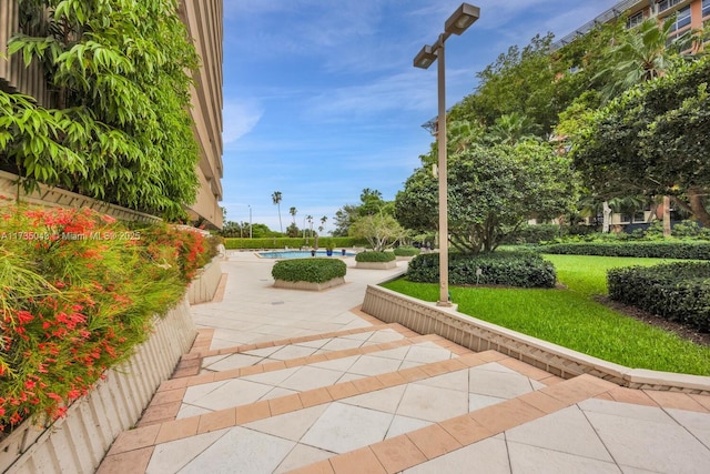 view of property's community with a pool and a patio area