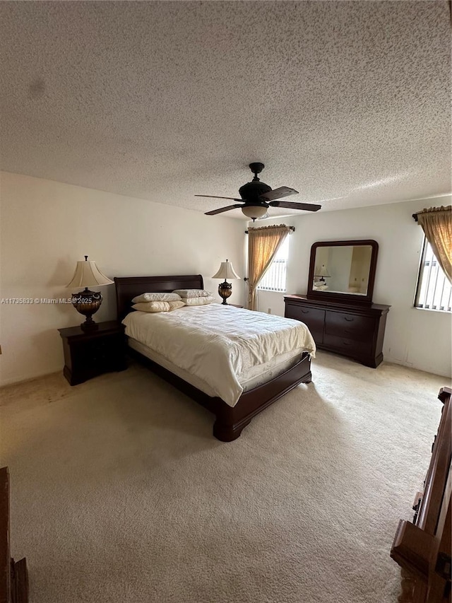 unfurnished bedroom featuring a textured ceiling, ceiling fan, and carpet flooring