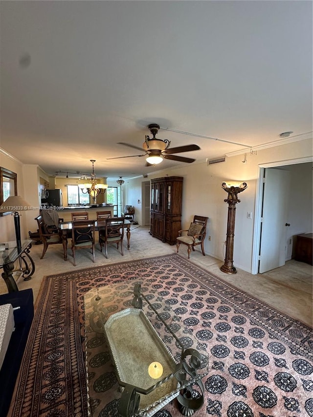 carpeted living room featuring ceiling fan with notable chandelier