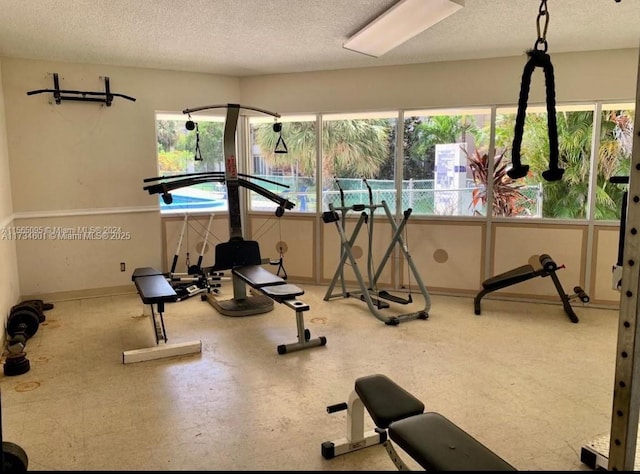 exercise room featuring a textured ceiling