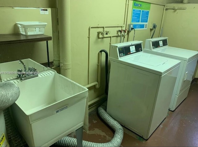 laundry area featuring washer and clothes dryer and sink