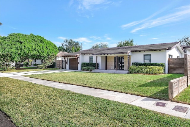 single story home with a garage and a front yard