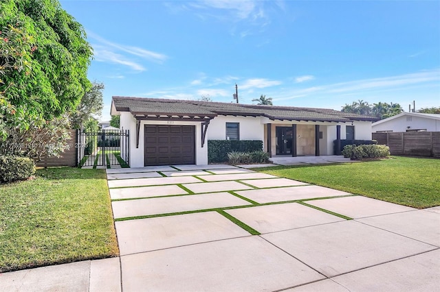 view of front of property featuring a garage and a front yard