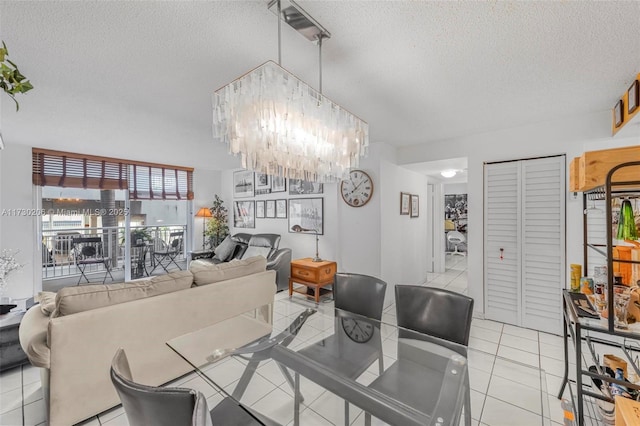 tiled dining space with a chandelier and a textured ceiling