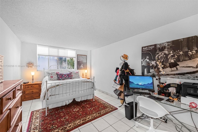 bedroom featuring light tile patterned flooring and a textured ceiling