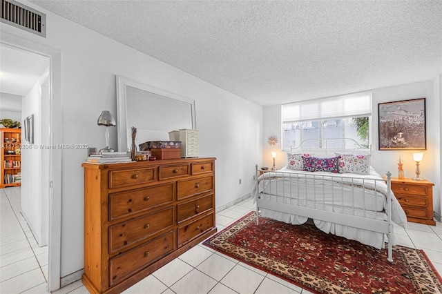 bedroom with light tile patterned floors and a textured ceiling