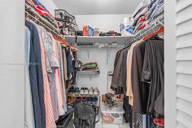 walk in closet with tile patterned floors