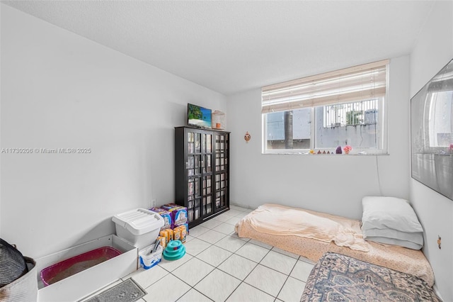 tiled bedroom with a textured ceiling