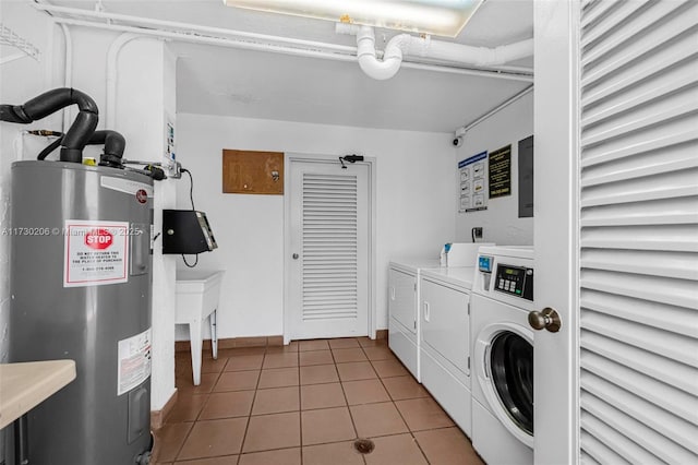 washroom with electric water heater, tile patterned floors, and washer and clothes dryer