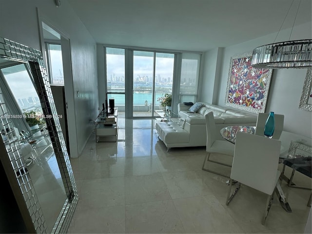 living room with a water view and floor to ceiling windows