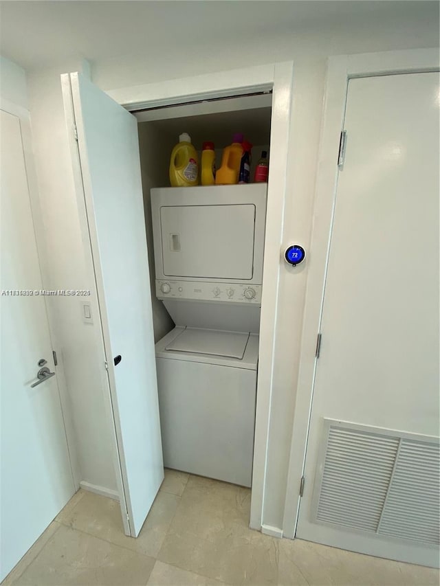 laundry room with stacked washer and dryer