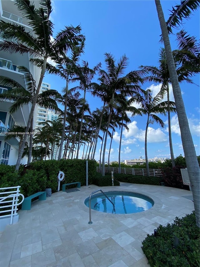 view of pool featuring an in ground hot tub