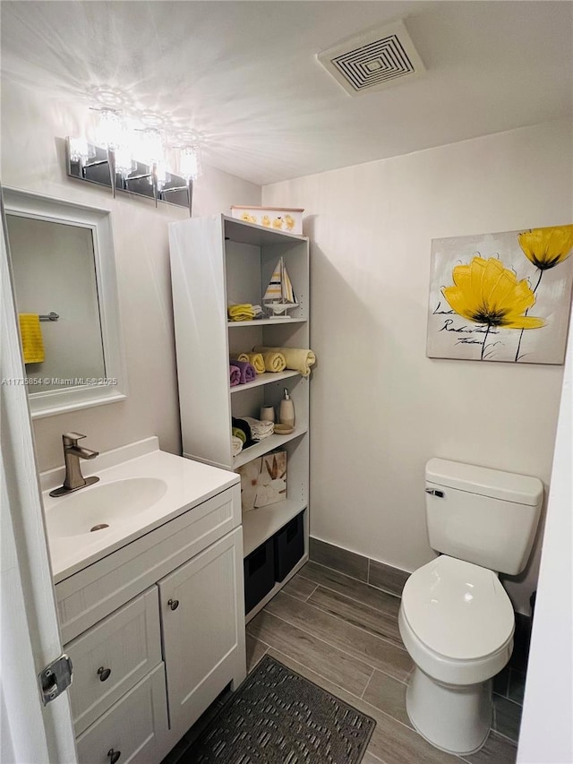 bathroom featuring vanity and toilet