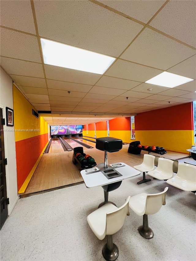 playroom with a bowling alley and a drop ceiling