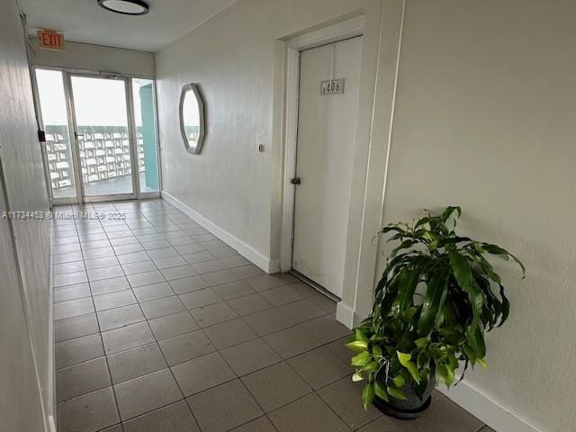 hall with light tile patterned floors