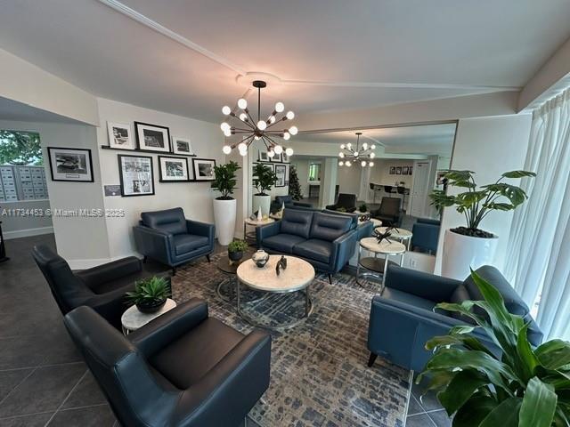 tiled living room with a wealth of natural light and a notable chandelier