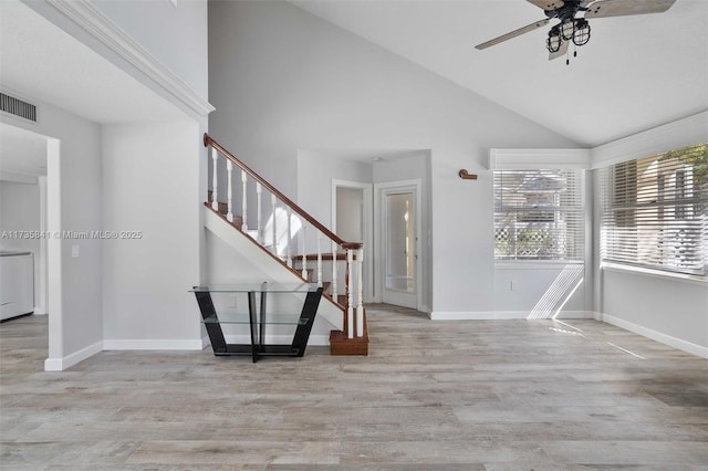 foyer featuring ceiling fan, high vaulted ceiling, and light hardwood / wood-style flooring