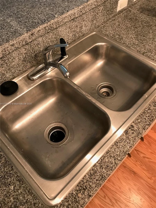 interior details with hardwood / wood-style flooring and sink
