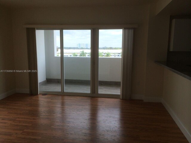 empty room with dark wood-type flooring