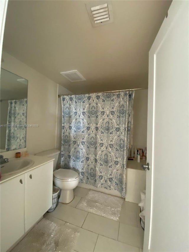 bathroom with tile patterned flooring, vanity, and toilet