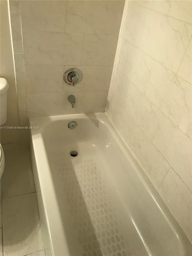 bathroom featuring a bathtub and toilet