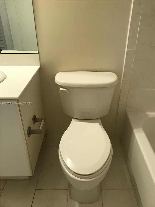 bathroom with tile patterned flooring, a washtub, and toilet