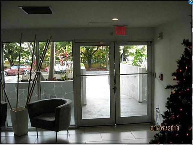doorway to outside featuring light tile patterned floors and french doors