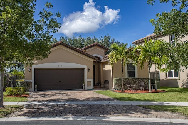 mediterranean / spanish-style house with a front yard