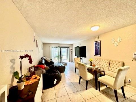 tiled living room with a textured ceiling