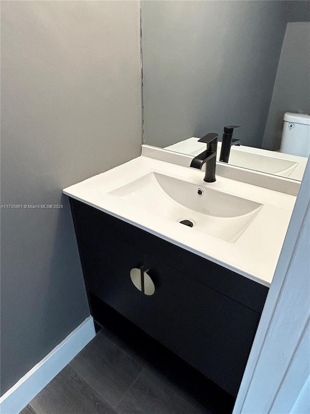 bathroom featuring vanity and toilet