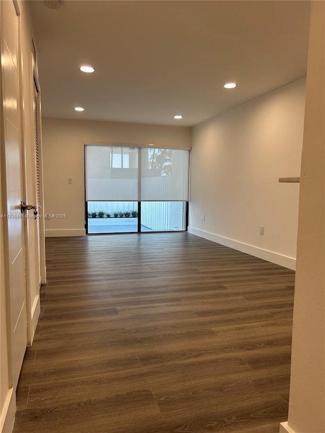 unfurnished room with dark hardwood / wood-style floors