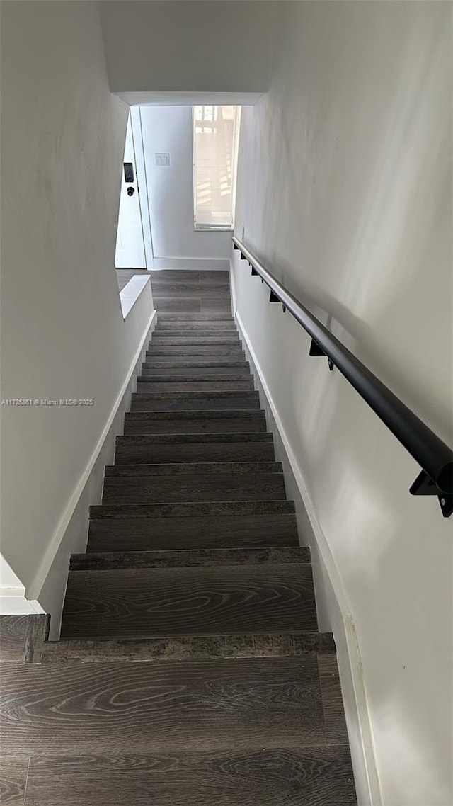 staircase with hardwood / wood-style floors