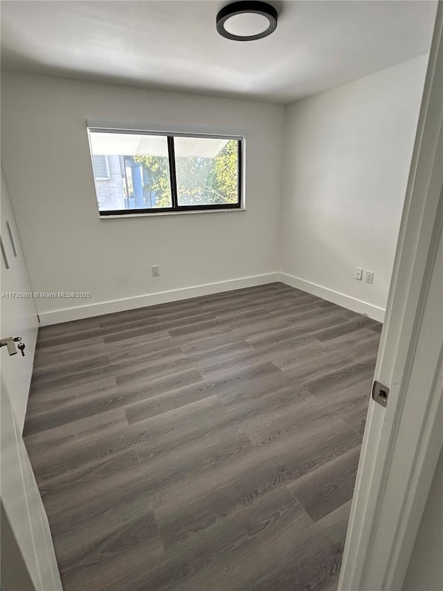 empty room featuring dark hardwood / wood-style floors