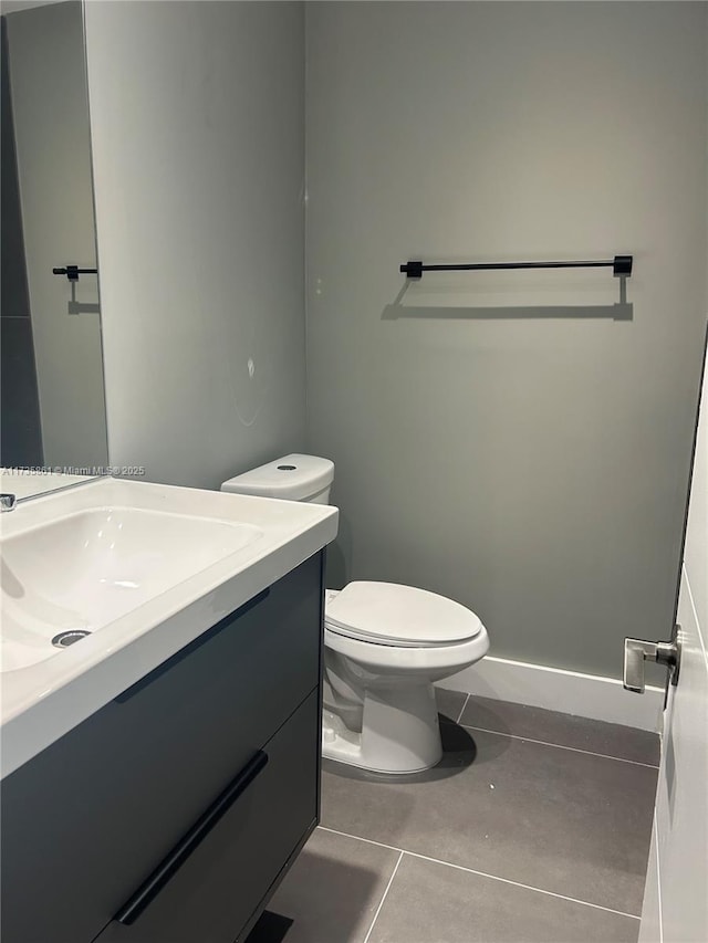 bathroom with vanity, tile patterned floors, and toilet