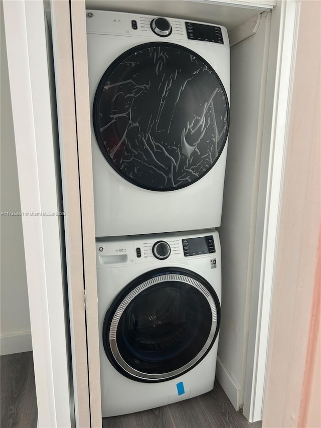 laundry room with stacked washer / dryer