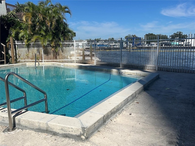 view of swimming pool with a water view