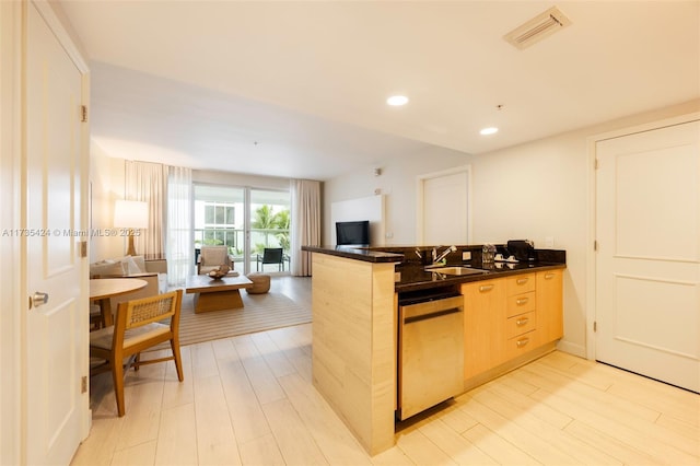 kitchen featuring sink, stainless steel dishwasher, kitchen peninsula, light brown cabinets, and light wood-type flooring