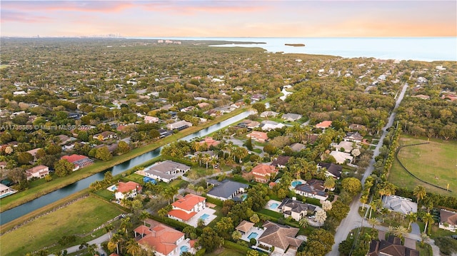 aerial view at dusk with a water view